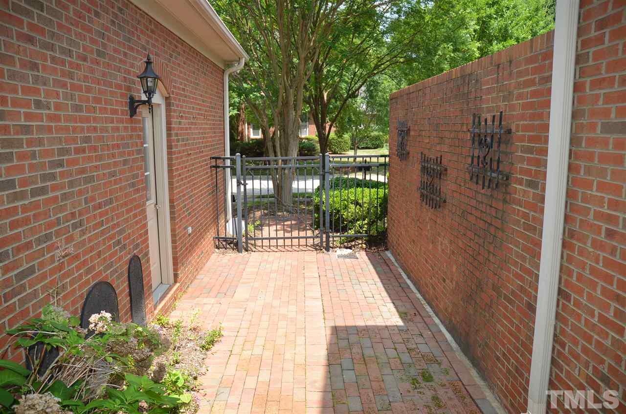 1843 Middlebrook Drive Raleigh, NC 27615 - Photo 3 of 13 a view of a pathway with a wooden fence
