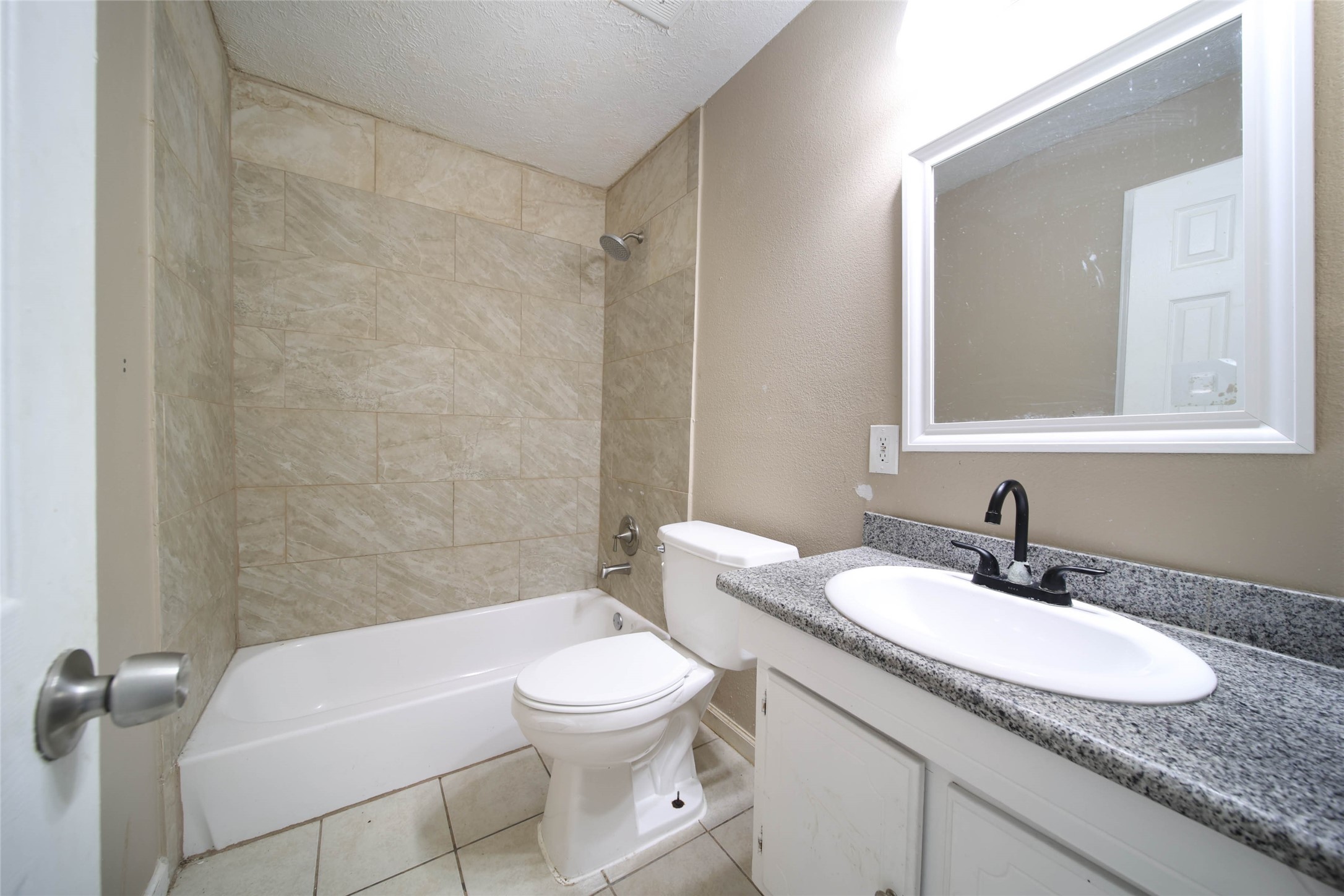8718 Pattibob Street Houston, TX 77029 - Photo 14 of 14 a bathroom with a granite countertop sink a toilet and a mirror