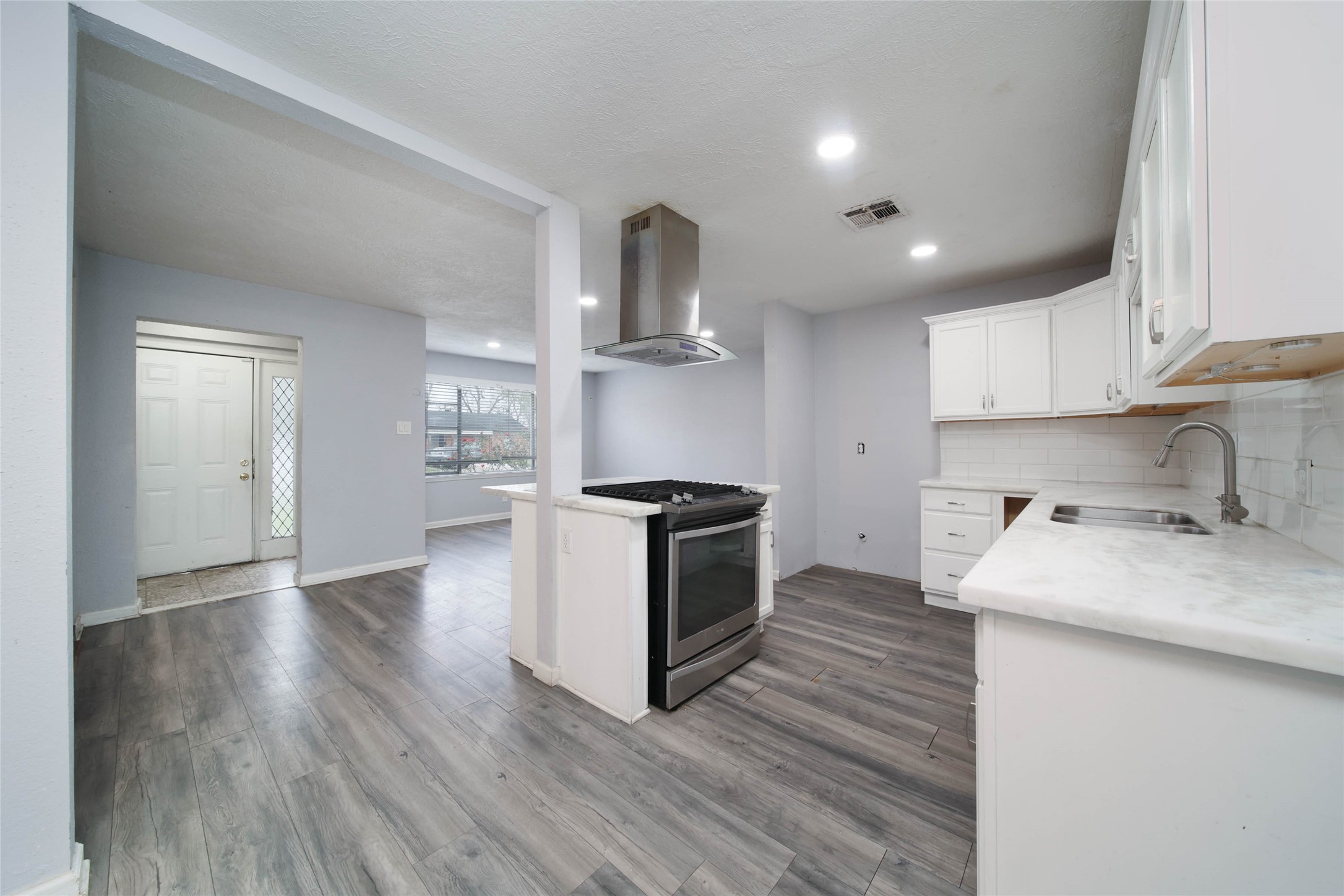 8718 Pattibob Street Houston, TX 77029 - Photo 3 of 14 a kitchen with a sink and a stove top oven