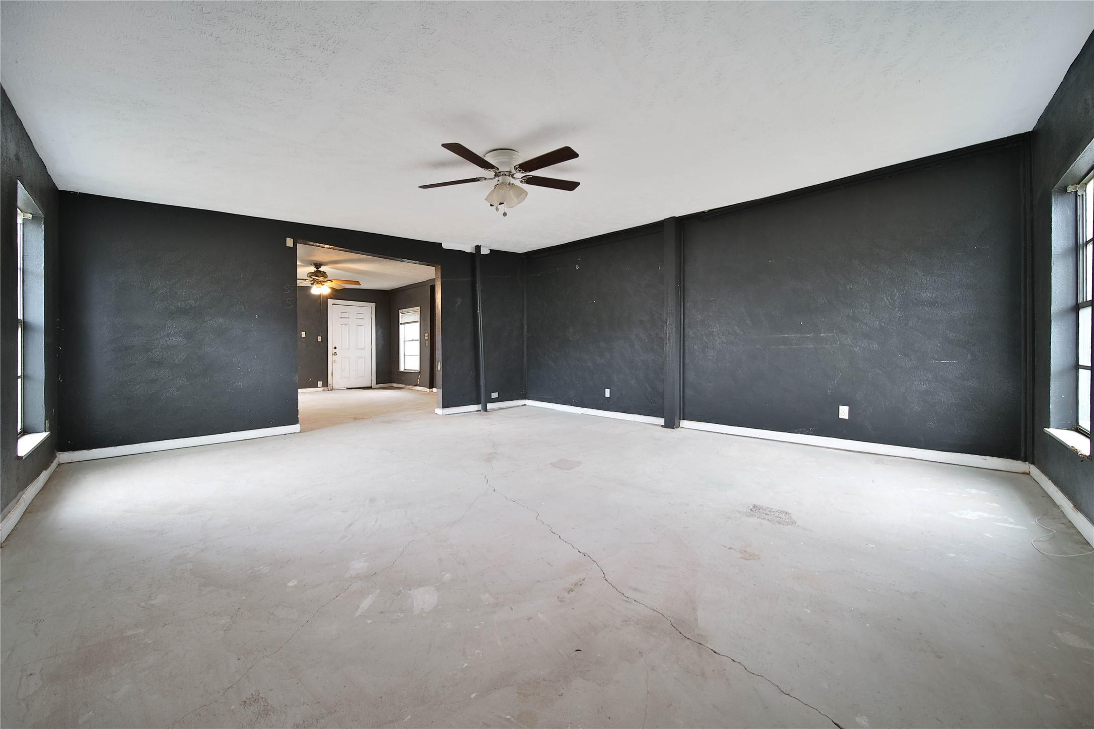 8718 Pattibob Street Houston, TX 77029 - Photo 5 of 14 a view of a big room with closet and chandelier fan