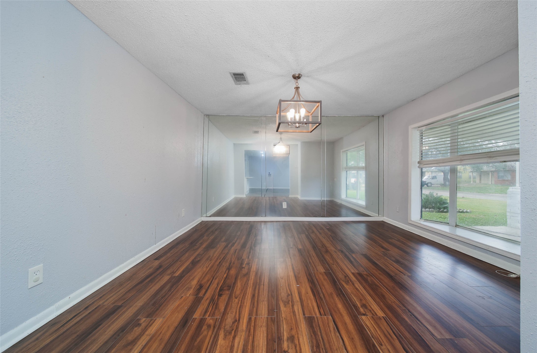8718 Pattibob Street Houston, TX 77029 - Photo 7 of 14 a view of an empty room with wooden floor and a window