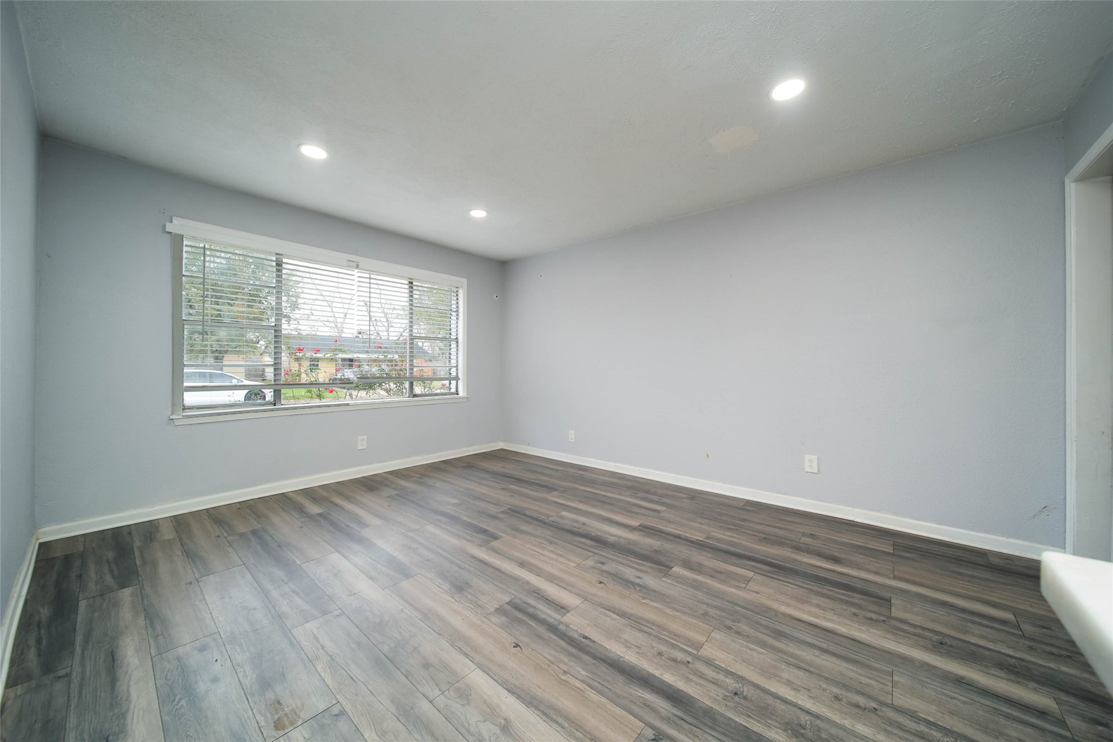 8718 Pattibob Street Houston, TX 77029 - Photo 10 of 14 an empty room with wooden floor and windows