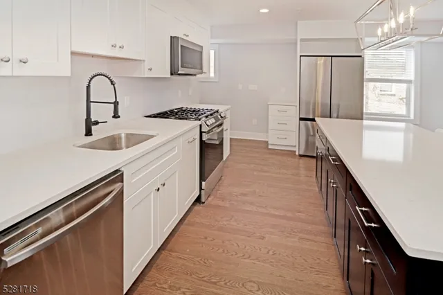 a kitchen with stainless steel appliances granite countertop a sink and cabinets