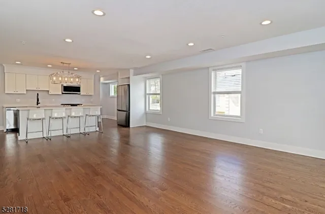 a view of a kitchen with cabinets and wooden floor