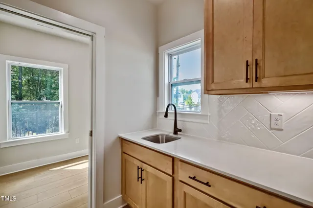 a kitchen with a stove sink and a fireplace with wooden floor