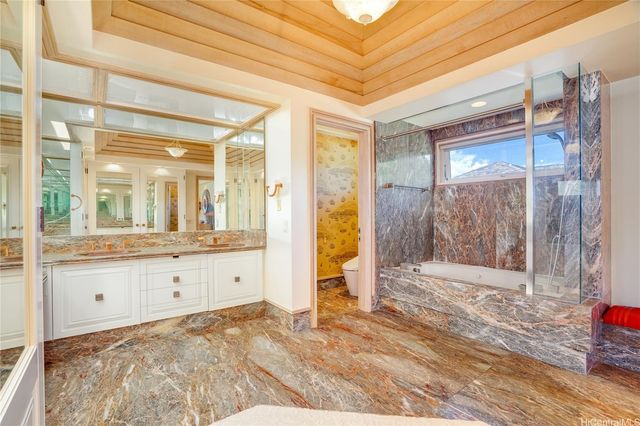 a bathroom with a sink a mirror and a shower