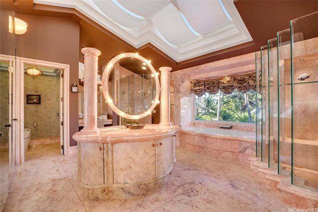 a view of a white house with a big yard and potted plants