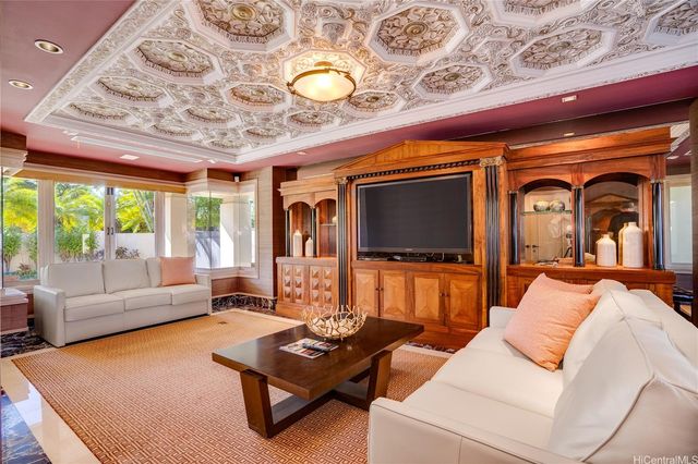 a dining room with furniture a chandelier and wooden floor
