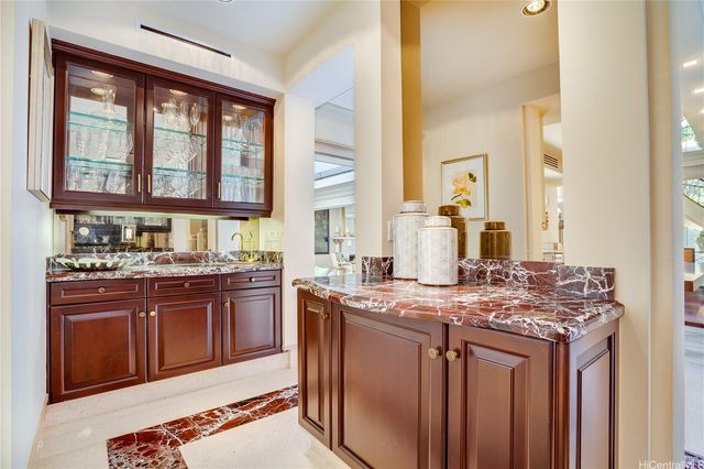 a large kitchen with stainless steel appliances granite countertop a stove and large windows