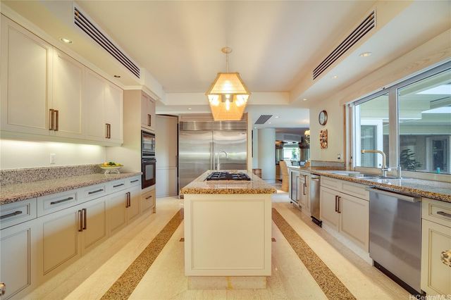 a kitchen with stainless steel appliances granite countertop a stove and a sink