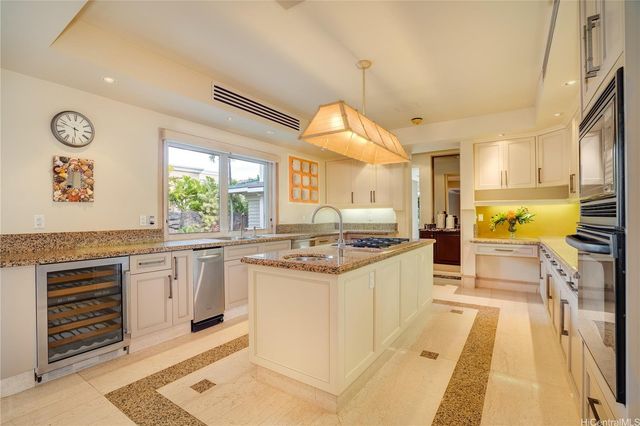 a dining room with furniture a large window and a chandelier
