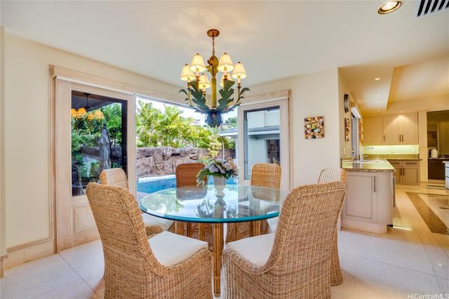 a living room with a couch and a potted plant