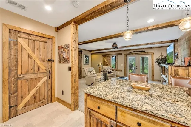 a view of living room with granite countertop furniture and floor to ceiling window