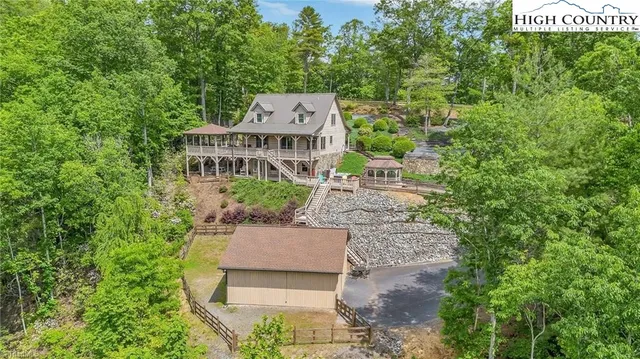 a aerial view of a house with yard and patio