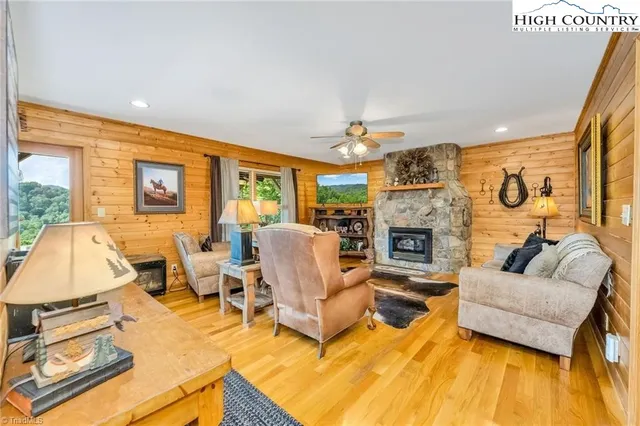 a living room with fireplace furniture and a large window
