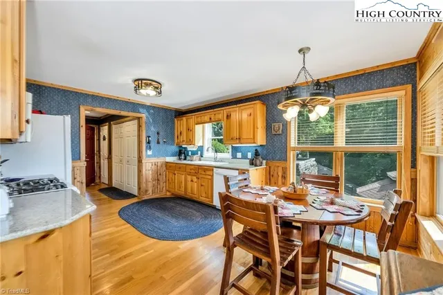 a dining room with furniture and a floor to ceiling window