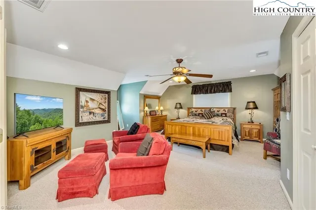 a bedroom with furniture and a flat screen tv
