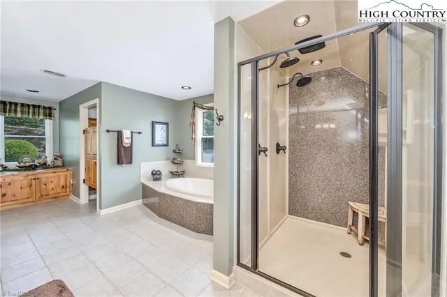 a bathroom with a tub shower and sink