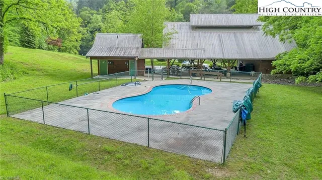 a swimming pool with outdoor seating and yard