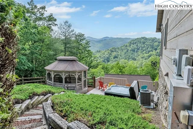a view of a patio with furniture and a yard