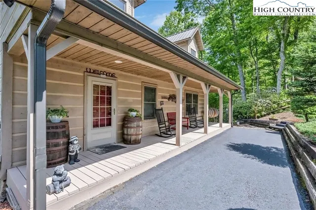 a view of a house with backyard porch and sitting area