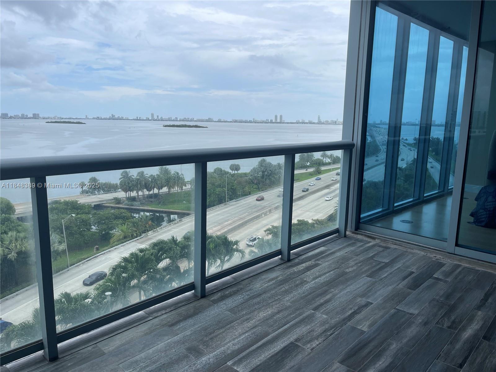 601 Northeast 36th Street, Unit 1009 Miami, FL 33137 - Photo 17 of 19 a view of a balcony with wooden floor