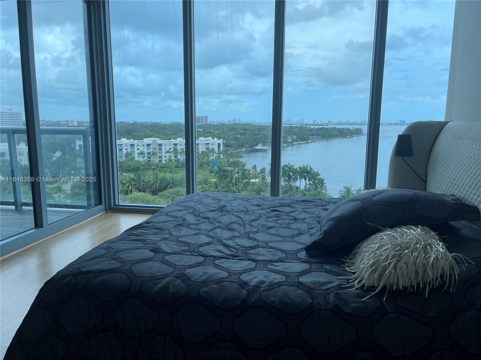 601 Northeast 36th Street, Unit 1009 Miami, FL 33137 - Photo 9 of 19 a bedroom with a bed and a large window