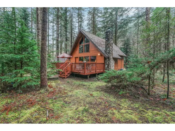 a house with tall trees in the background