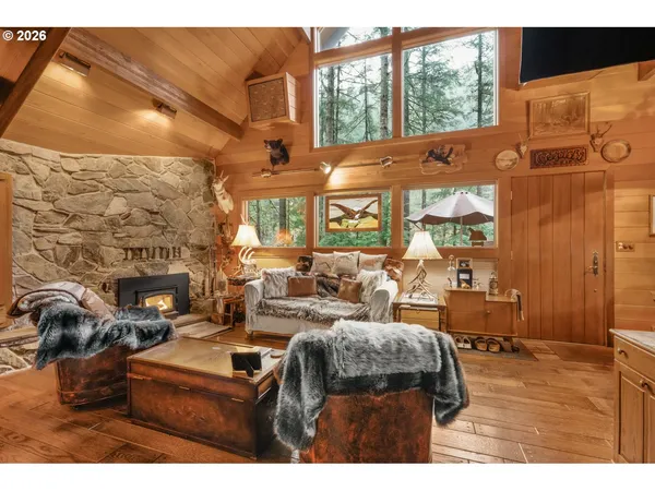 a living room with furniture a large window and a fireplace