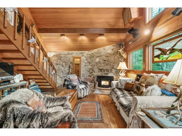 a living room with fireplace furniture and a floor to ceiling window
