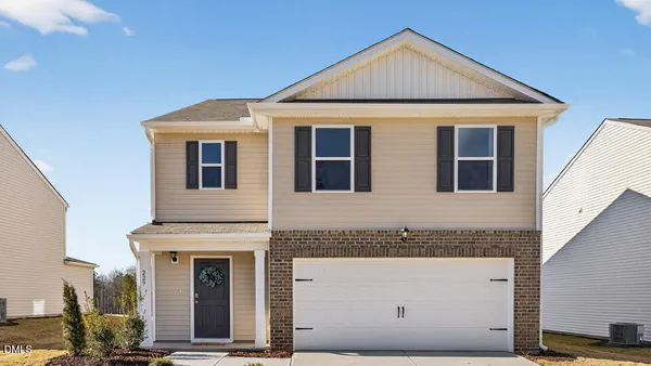 a front view of a house with a garage