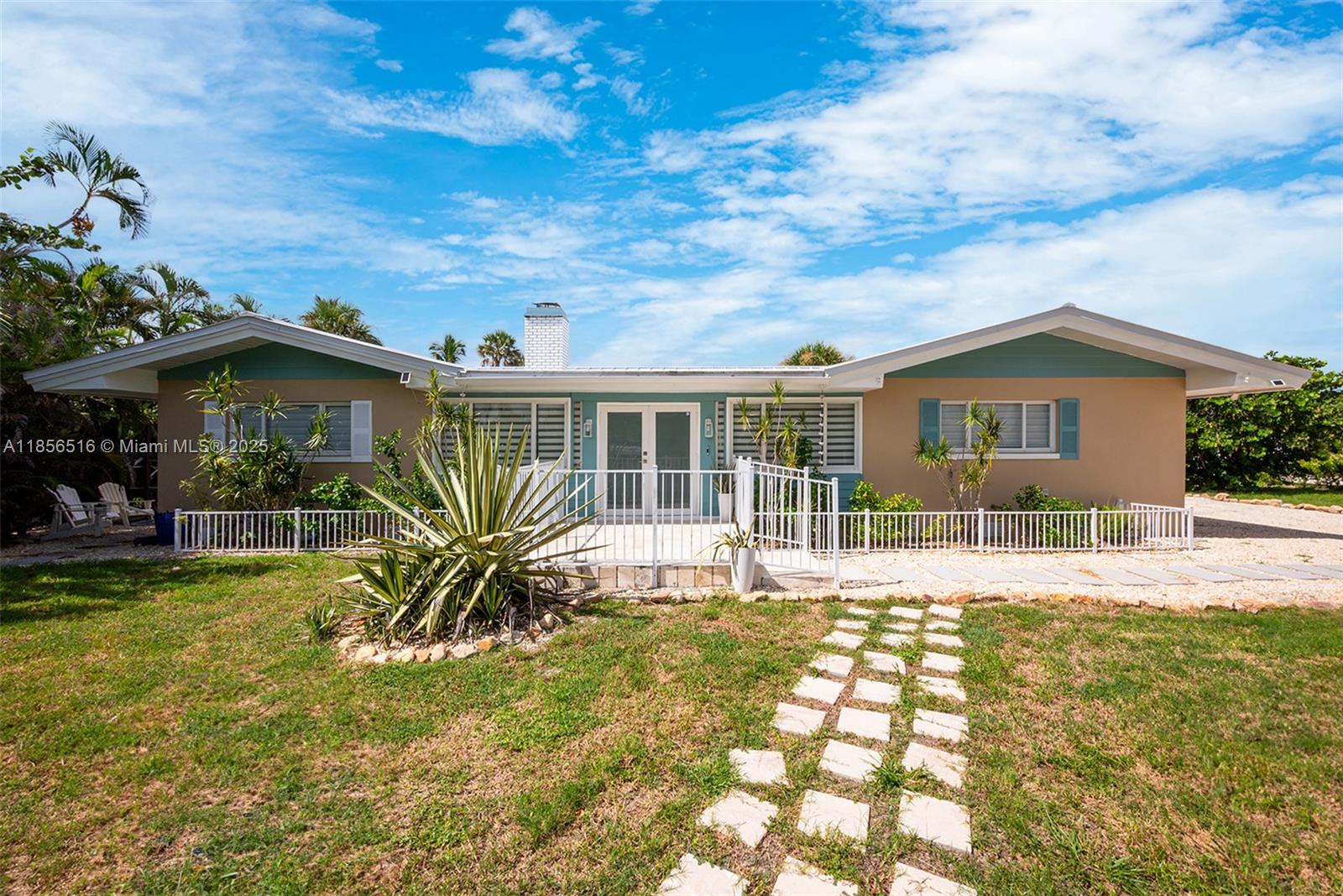 5885 Pine Tree Drive Sanibel, FL 33957 - Photo 11 of 56 a view of a house with a patio