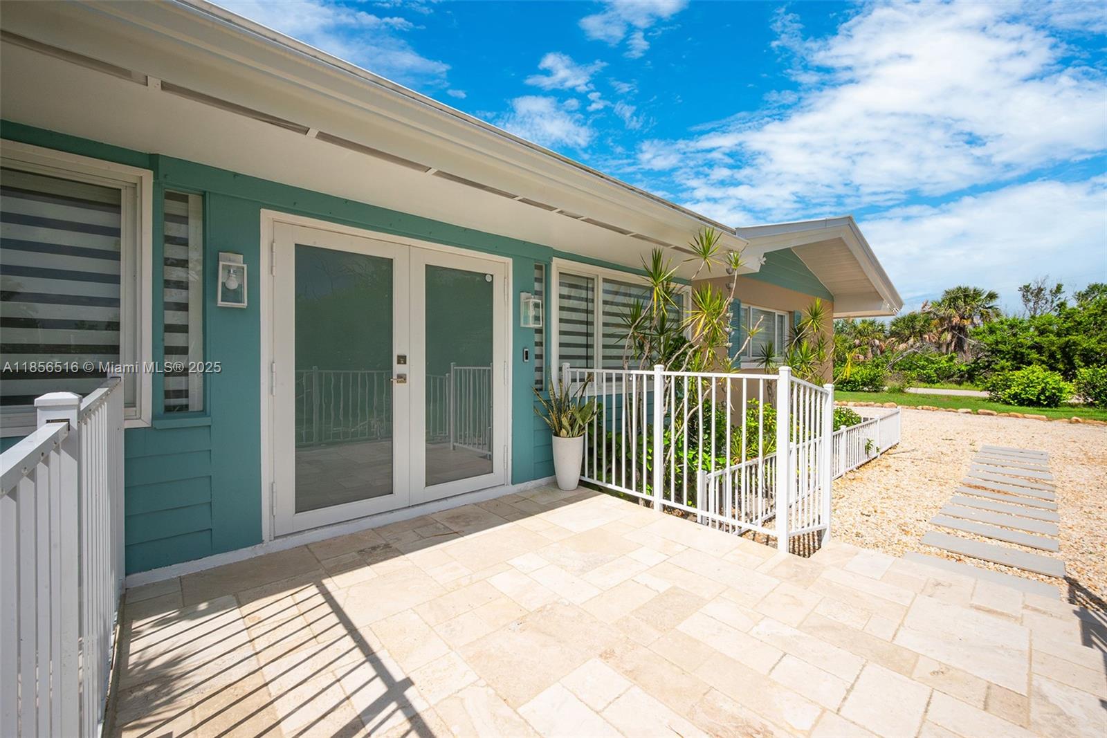 5885 Pine Tree Drive Sanibel, FL 33957 - Photo 13 of 56 a view of a house with backyard and porch