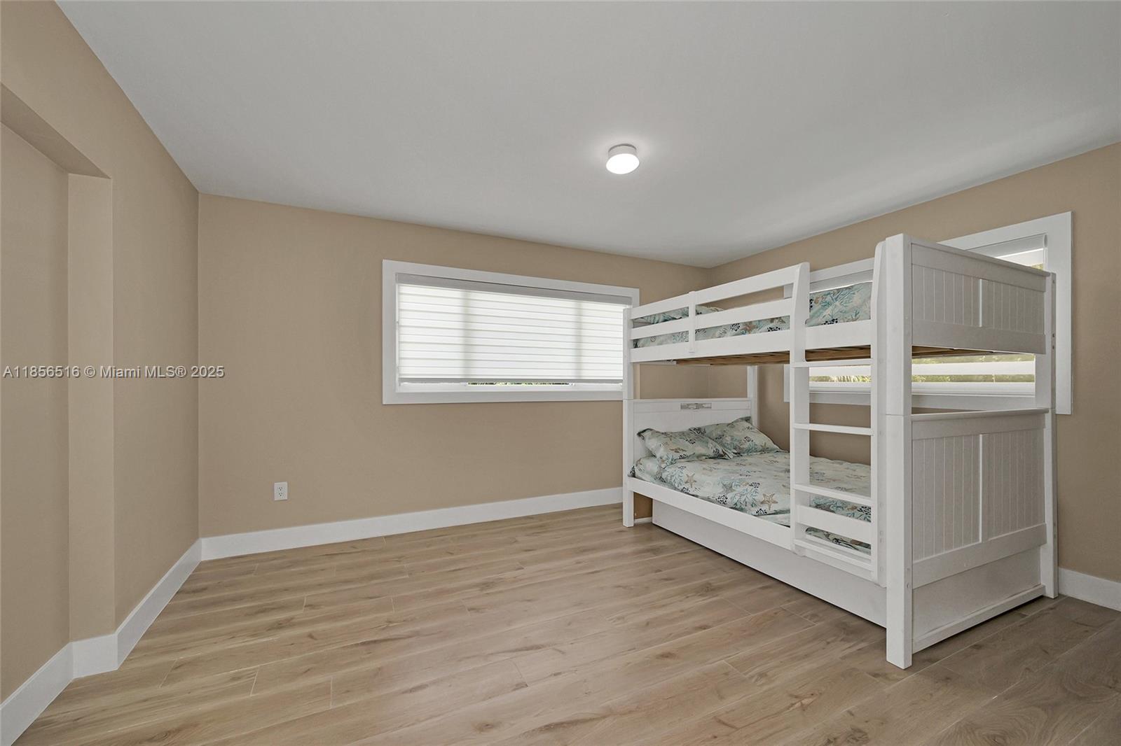 5885 Pine Tree Drive Sanibel, FL 33957 - Photo 30 of 56 a view of an empty room with a window and wooden floor