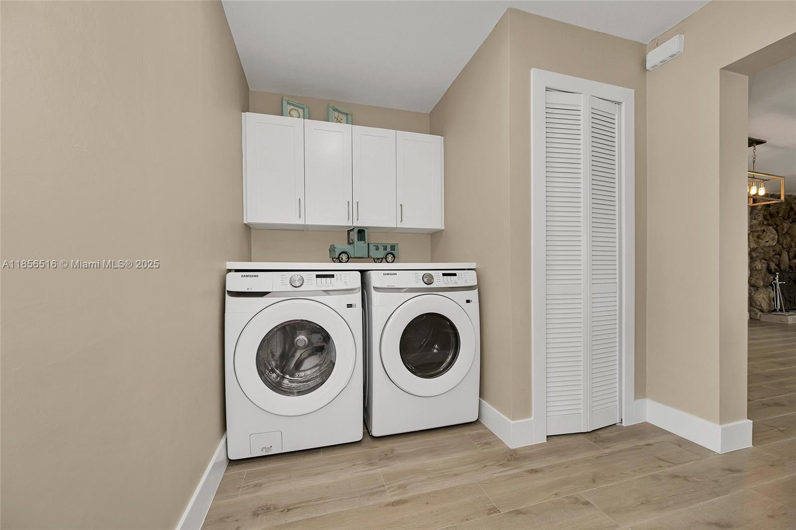 5885 Pine Tree Drive Sanibel, FL 33957 - Photo 36 of 56 a utility room with dryer and washer