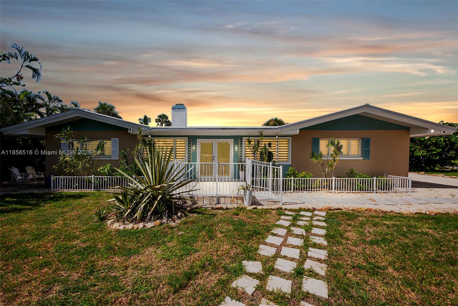 5885 Pine Tree Drive Sanibel, FL 33957 - Photo 56 of 56 a front view of a house with garden