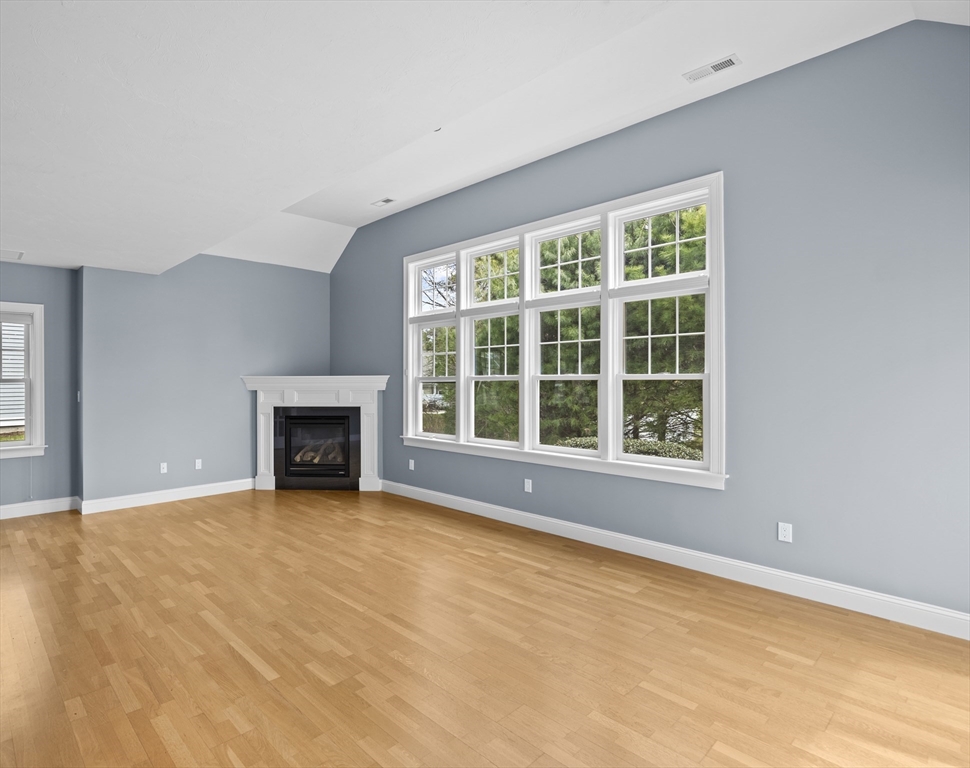 10 Mariner's Drive, Unit 10 Marshfield, MA 02050 - Photo 15 of 25 a view of an empty room with a fireplace and a window