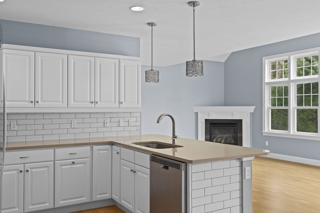 10 Mariner's Drive, Unit 10 Marshfield, MA 02050 - Photo 18 of 25 a kitchen with white cabinets and sink