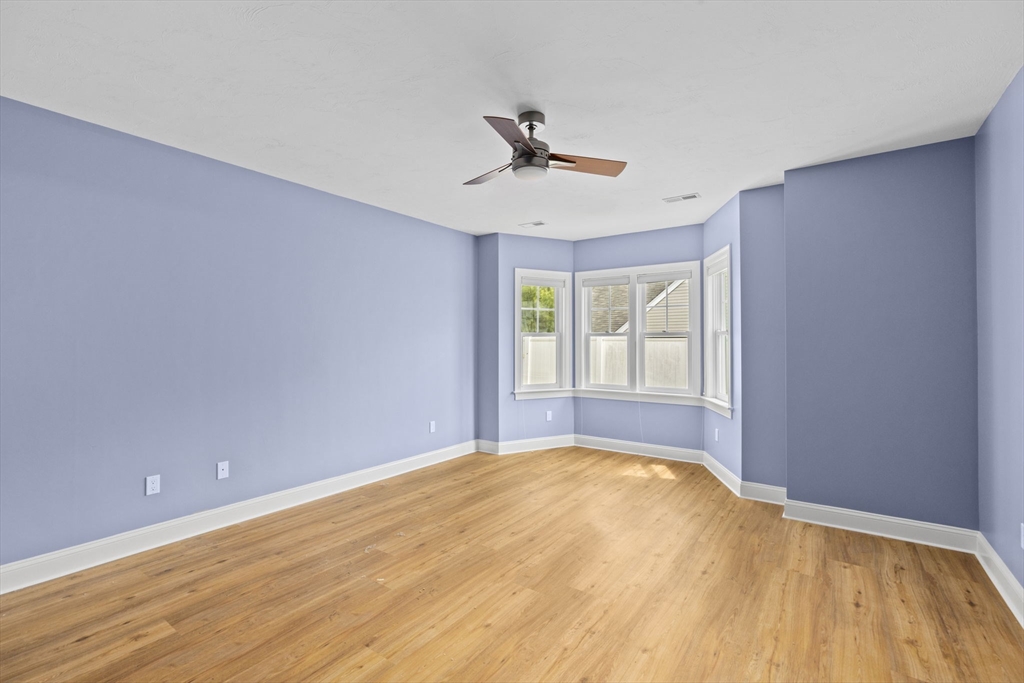 10 Mariner's Drive, Unit 10 Marshfield, MA 02050 - Photo 21 of 25 a view of empty room with wooden floor and fan