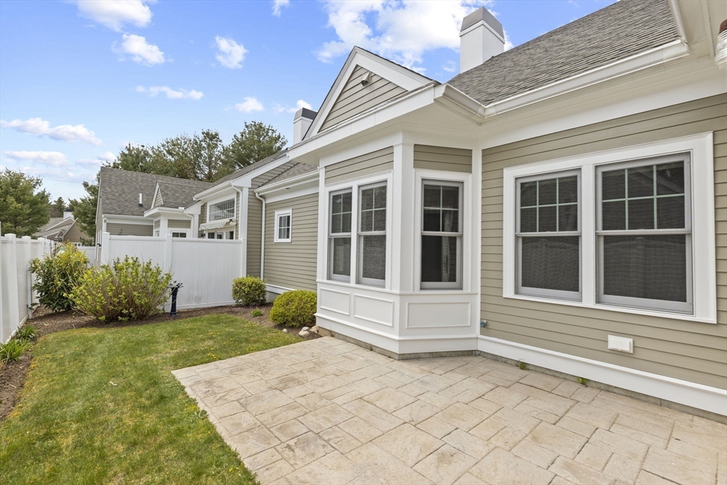 10 Mariner's Drive, Unit 10 Marshfield, MA 02050 - Photo 22 of 25 a front view of a house with a garden and plants