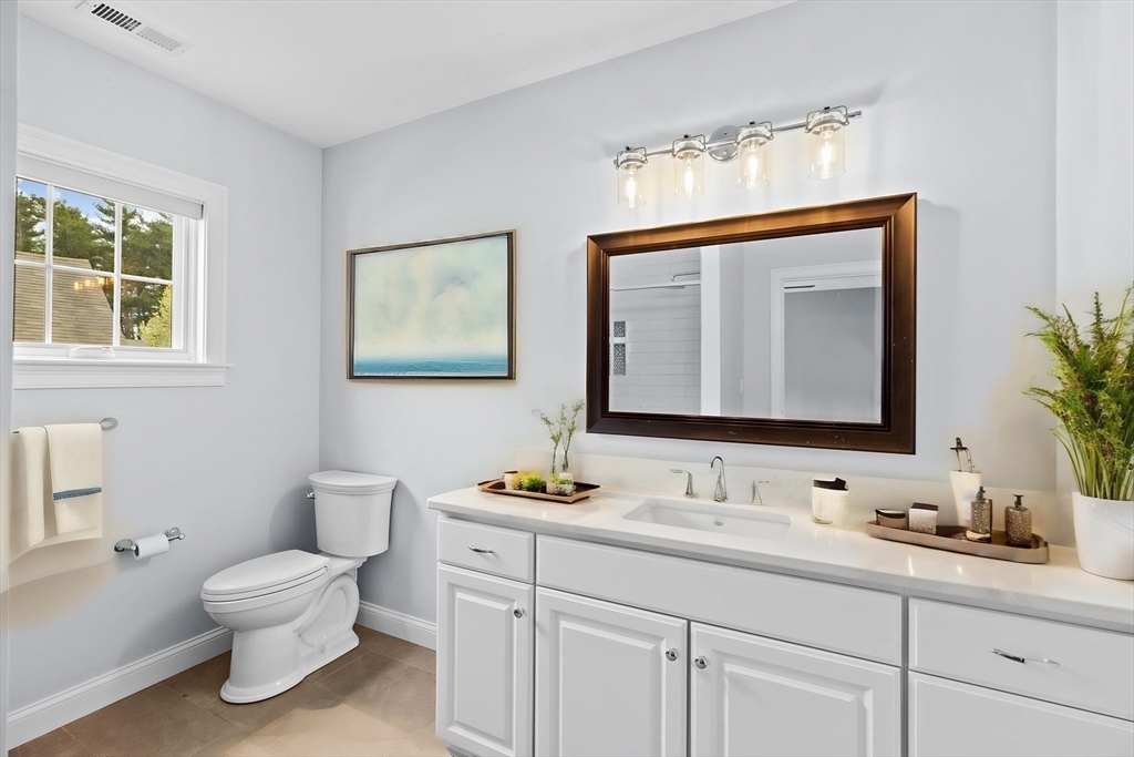 10 Mariner's Drive, Unit 10 Marshfield, MA 02050 - Photo 8 of 25 a bathroom with a toilet a sink and mirror