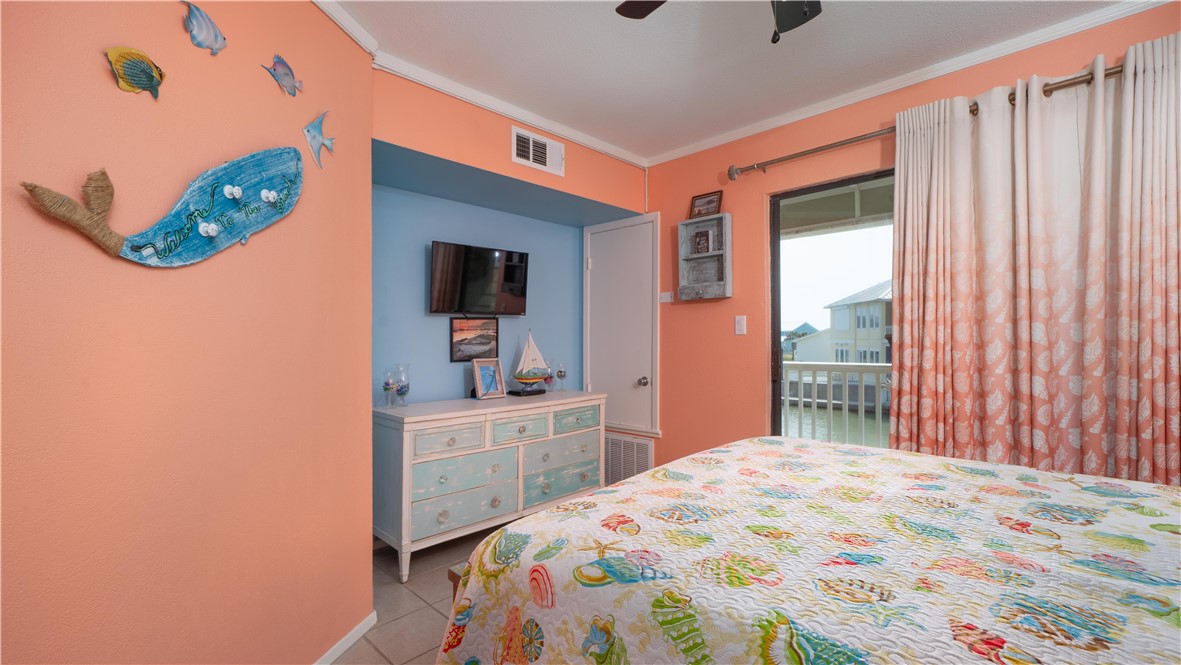 2290 North Fulton Beach Road Rockport, TX 78382 - Photo 19 of 26 a bedroom with a bed and a flat screen tv
