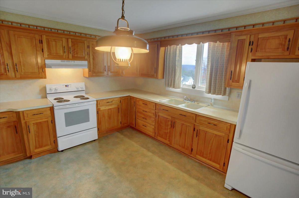 14625 Hilltop Road Cascade, MD 21719 - Photo 17 of 49 a kitchen with a stove a sink and a refrigerator