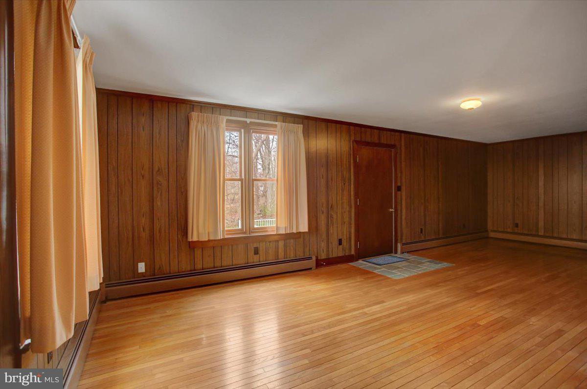 14625 Hilltop Road Cascade, MD 21719 - Photo 30 of 49 a view of an empty room with wooden floor and a window