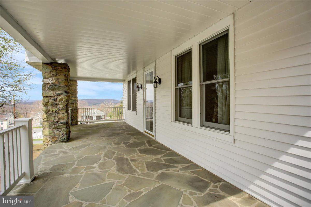 14625 Hilltop Road Cascade, MD 21719 - Photo 3 of 49 a view of a porch with a door and wooden floor