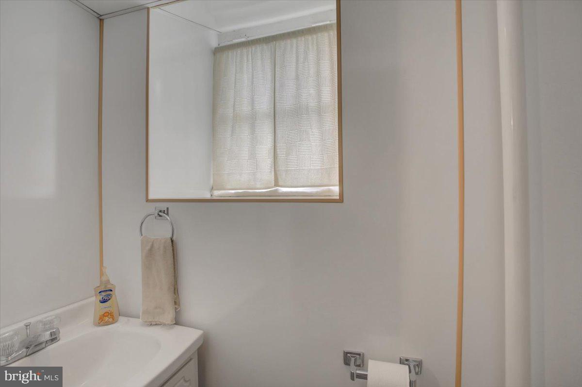 14625 Hilltop Road Cascade, MD 21719 - Photo 38 of 49 a bathroom with a sink and a window