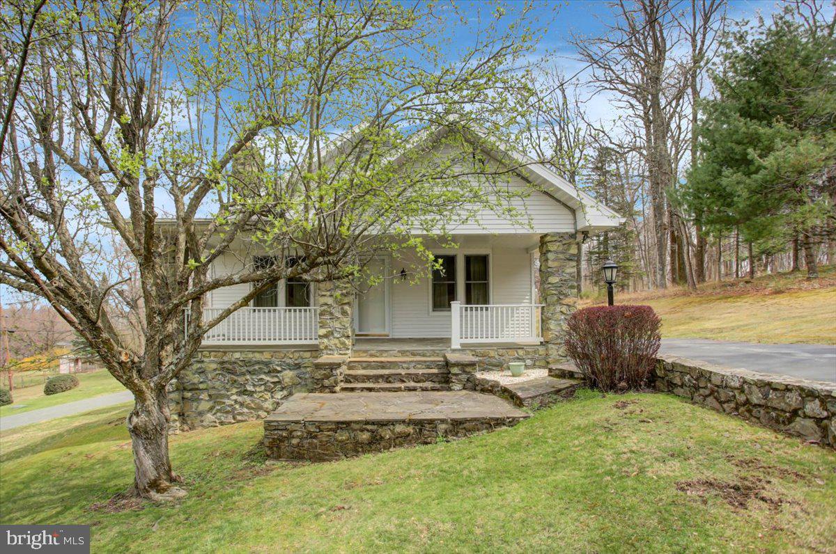 14625 Hilltop Road Cascade, MD 21719 - Photo 5 of 49 a front view of a house with garden
