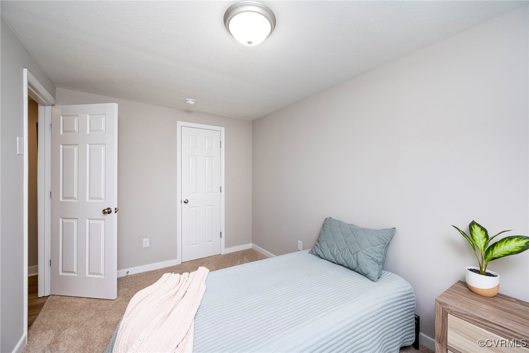 2821 Remington Road Henrico, VA 23231 - Photo 13 of 24 a bedroom with a bed and with potted plant
