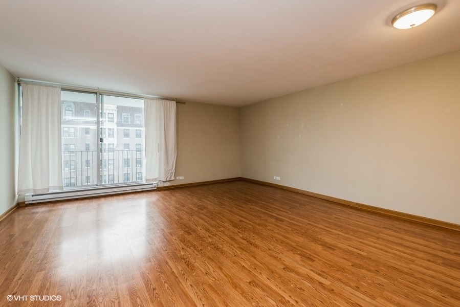 6033 North Sheridan Road, Unit 12K Chicago, IL 60660 - Photo 2 of 11 a view of an empty room and wooden floor