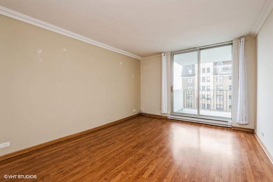 6033 North Sheridan Road, Unit 12K Chicago, IL 60660 - Photo 6 of 11 a view of an empty room with wooden floor and a window